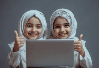 two-smiling-young-girls-hijabs-with-laptop-thumbs-up